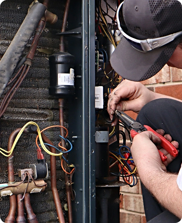 Worker holding pliers and repairing electrical wiring